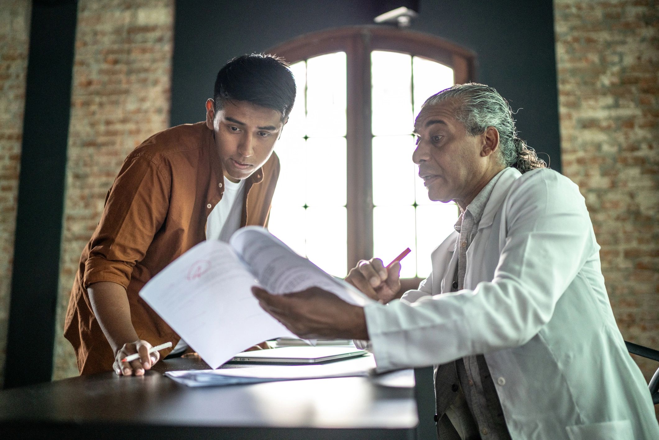 Consultant guiding a candidate at a desk