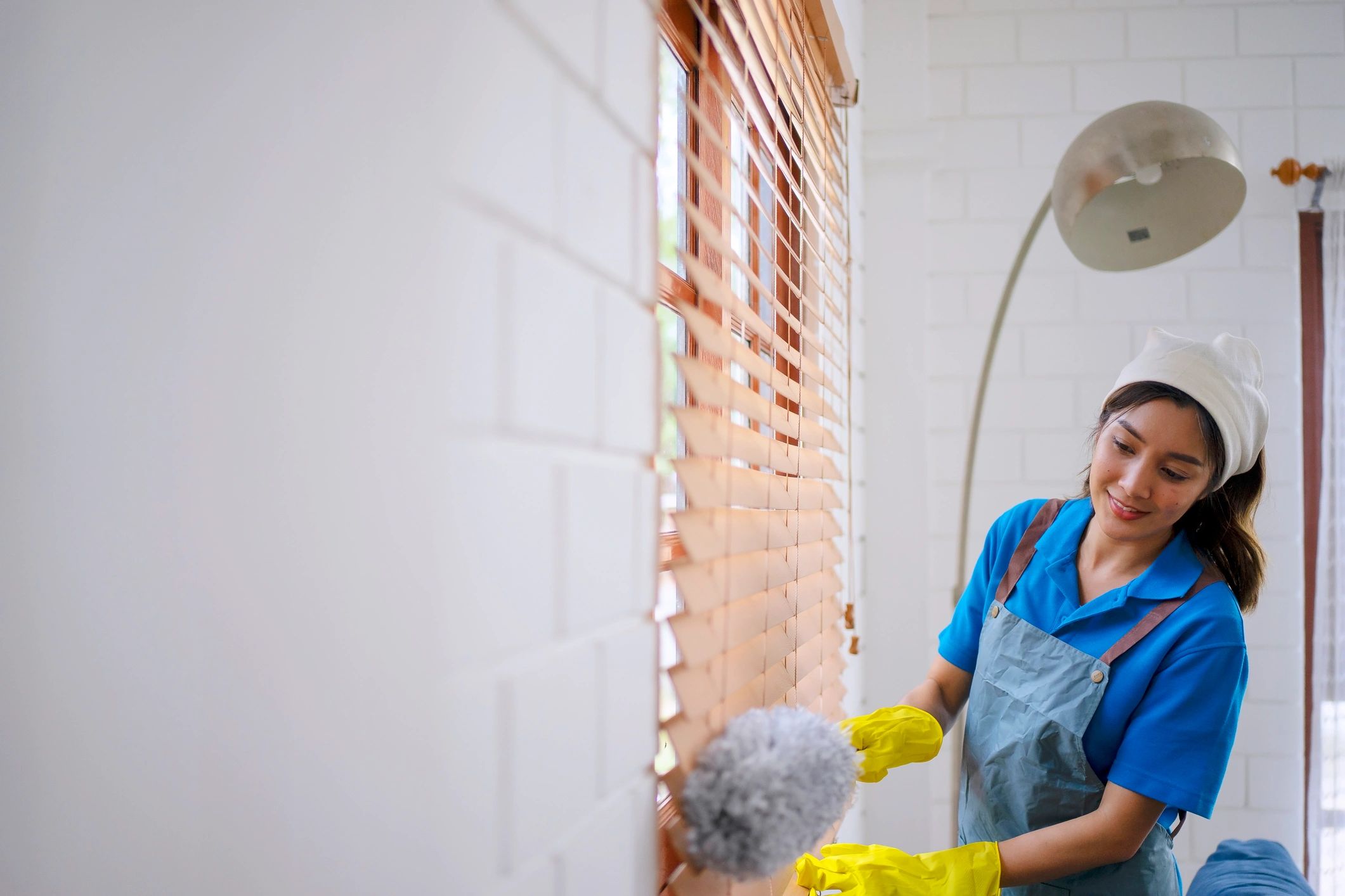 Housekeeper cleaning a living room