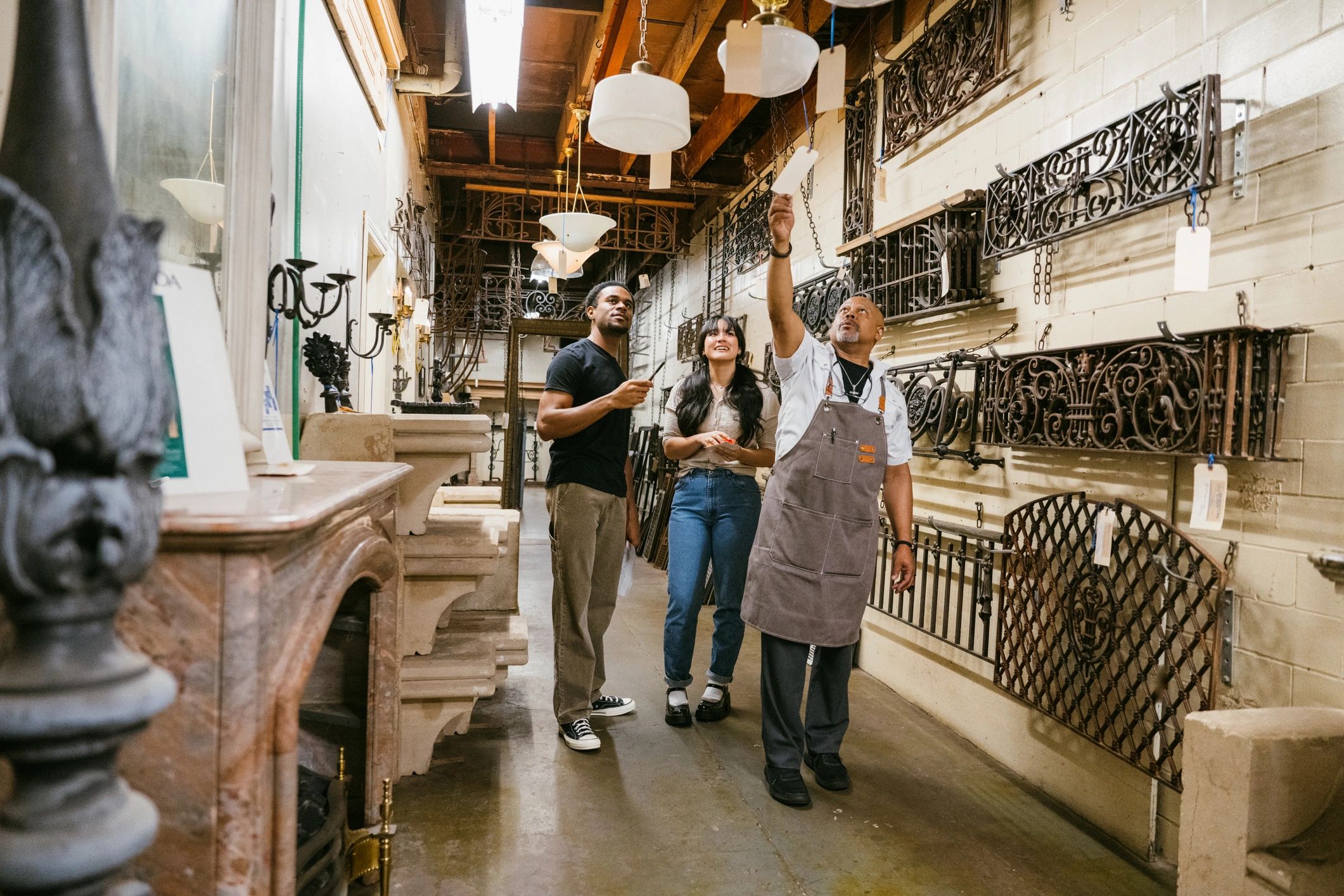 Retail staff helping customers in a lighting store