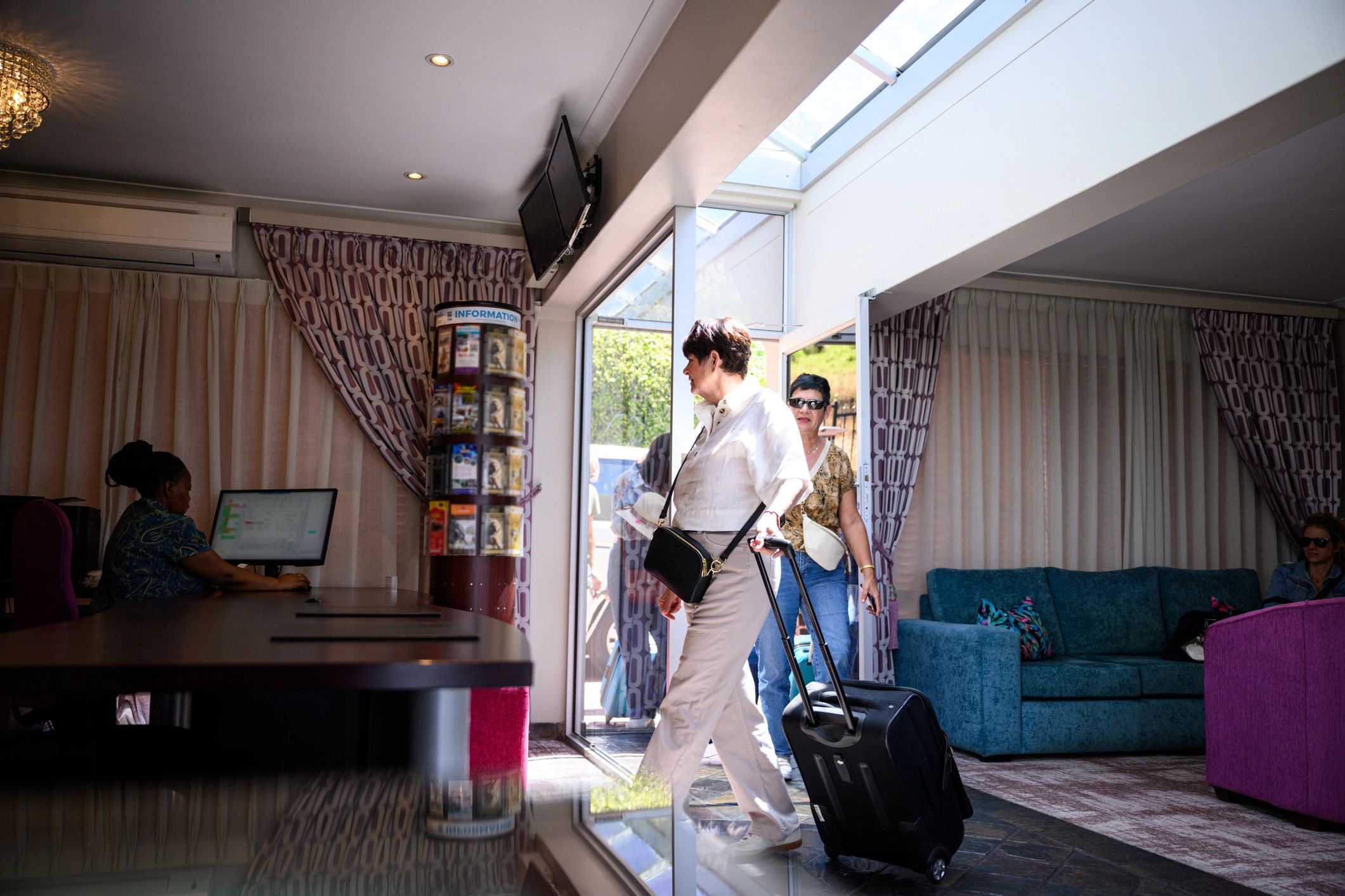 Guests arriving at a hotel reception area
